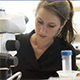 Blonde white woman working at a lab bench